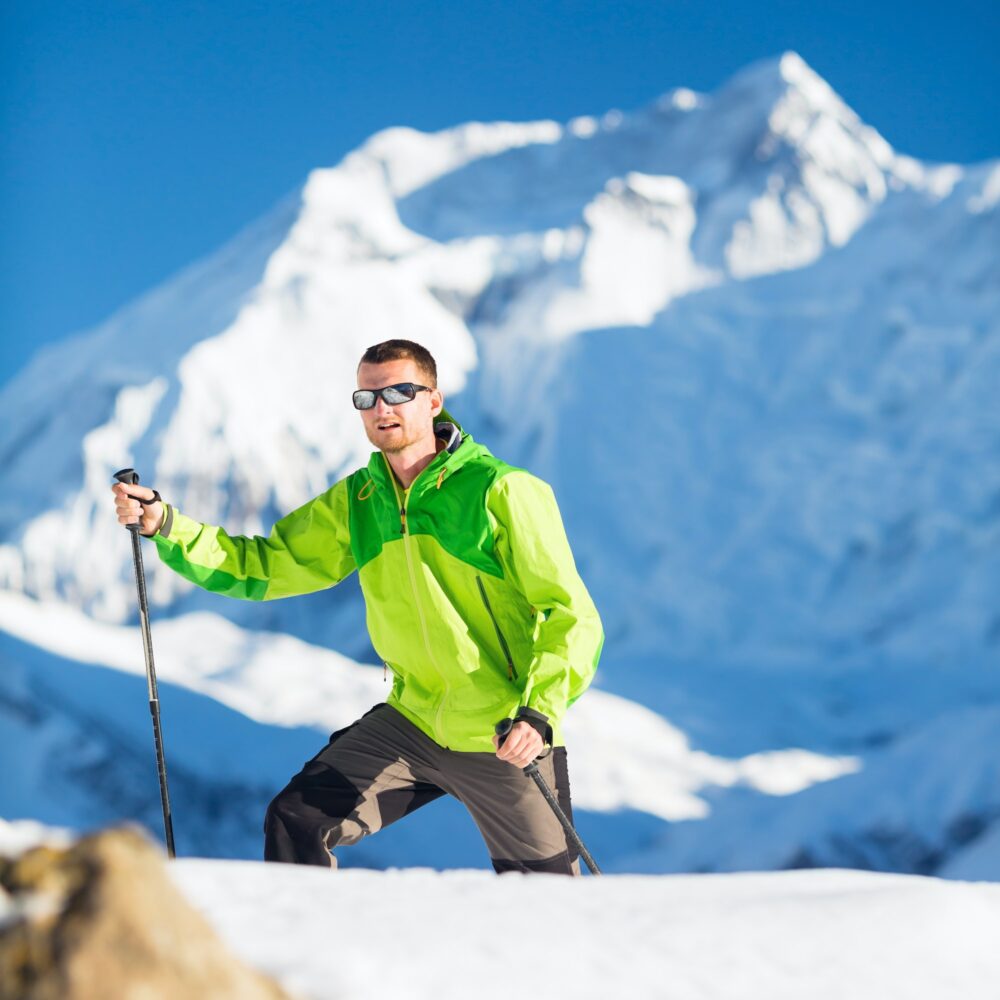 Man climbing exploring winter mountains